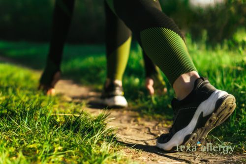 People walking on an outdoor pathway. with the Texa Allergy Logo in the bottom right corner.